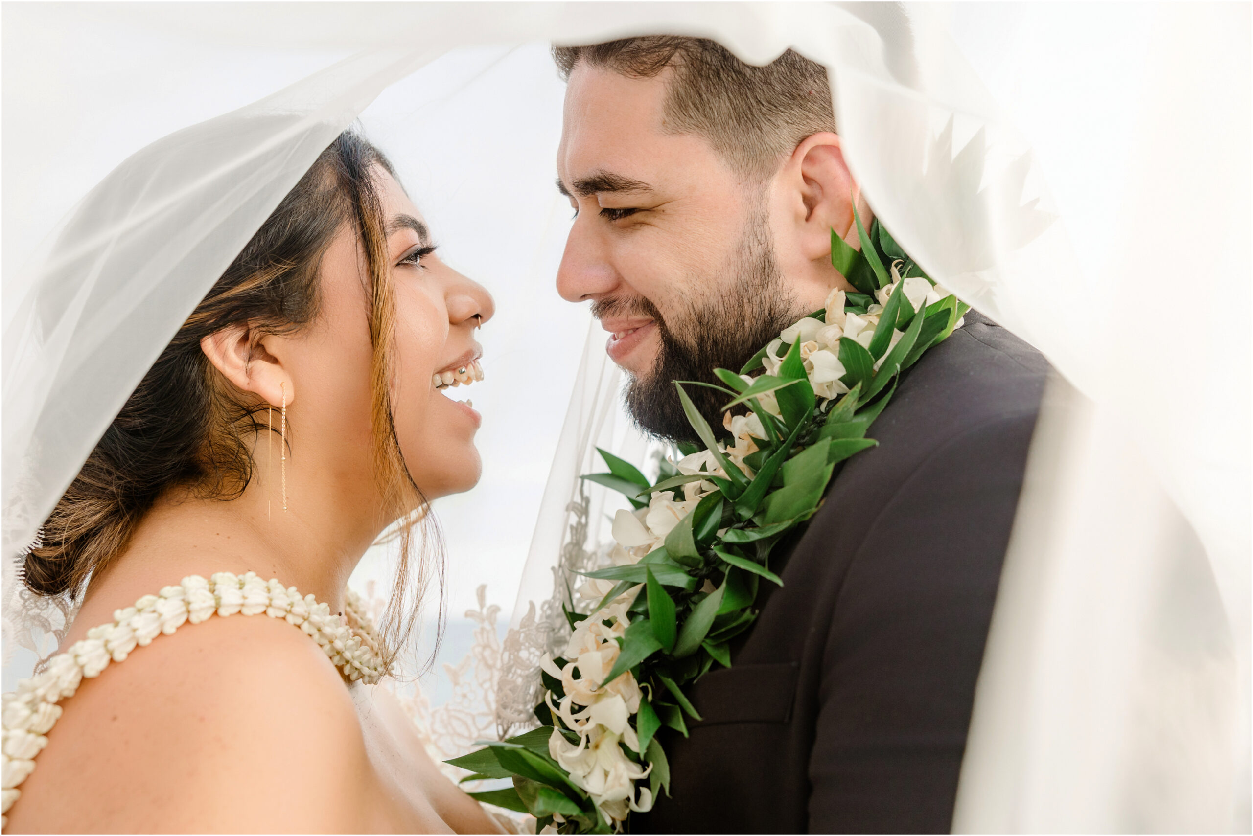 Bride and groom under veil