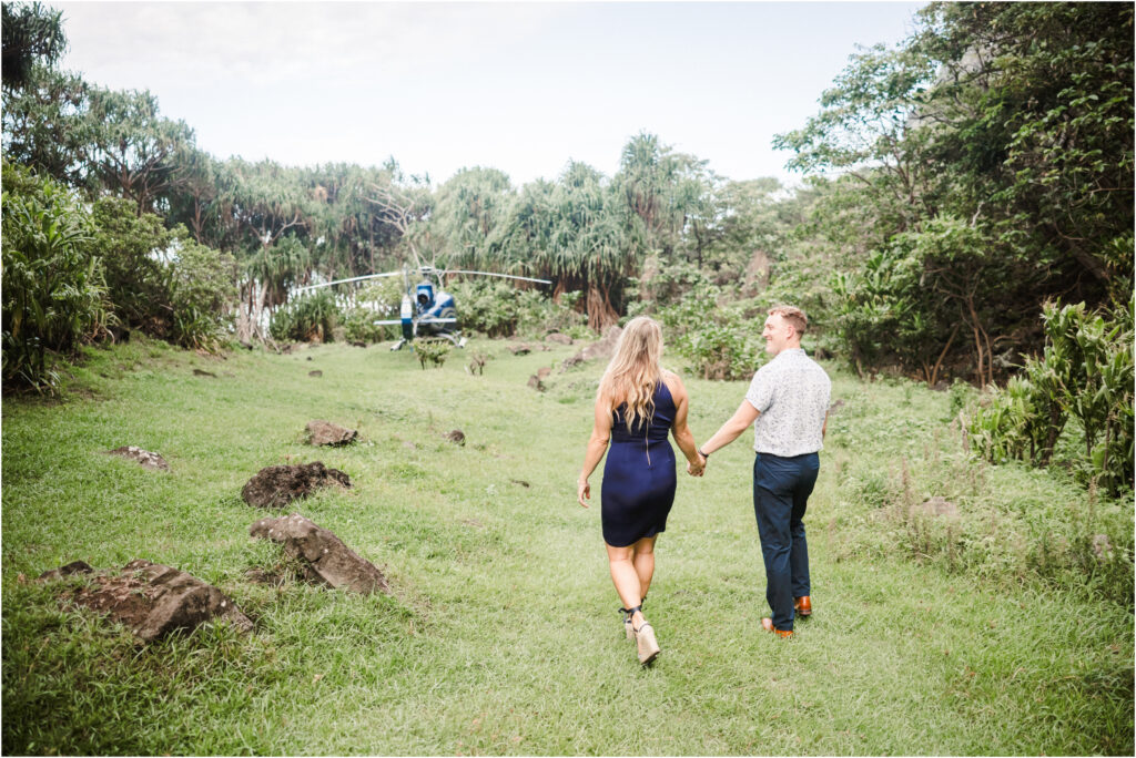 couple walking towards the helicopter